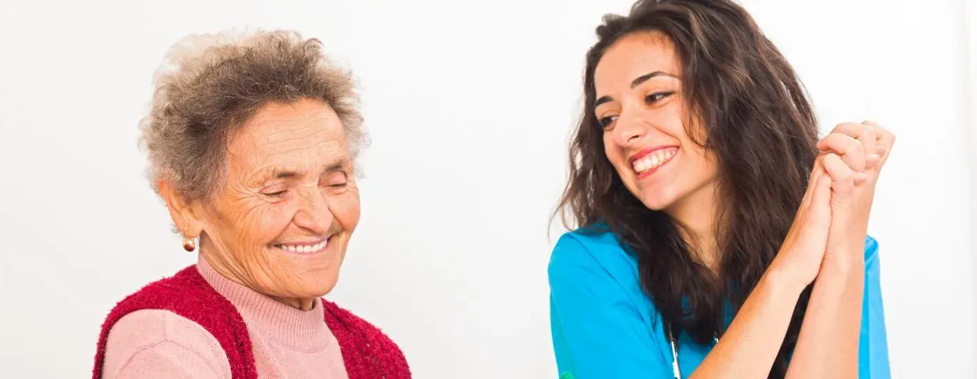 Smiling older woman and carer sharing a happy moment during elderly care at home in Dartford