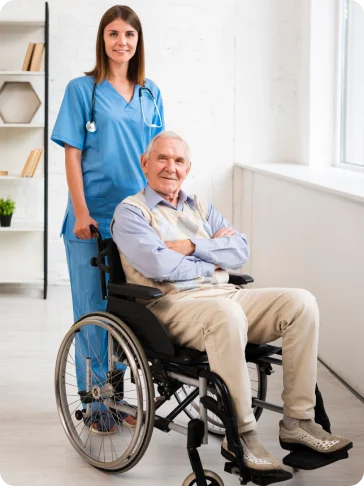 Mission Healthcare carer standing beside an older man in a wheelchair at home